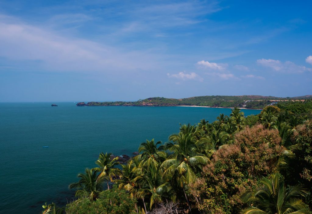 Goa travel guide scenic beach view with ocean waves and sunset sky